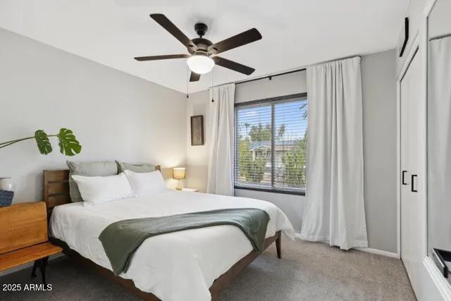 a bedroom with a large bed and a window