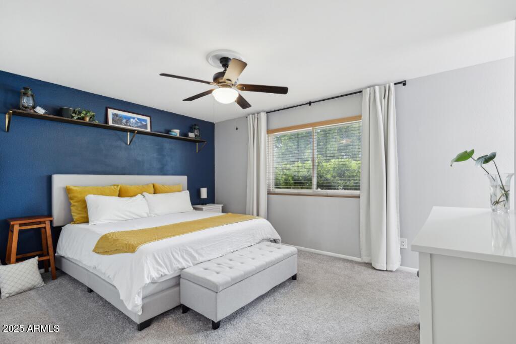 2163 East Sesame Street Tempe, AZ 85283 - Photo 10 of 16 a bedroom with a large bed and a chandelier