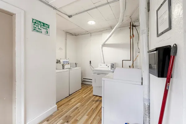 a room with a sink and a washer dryer