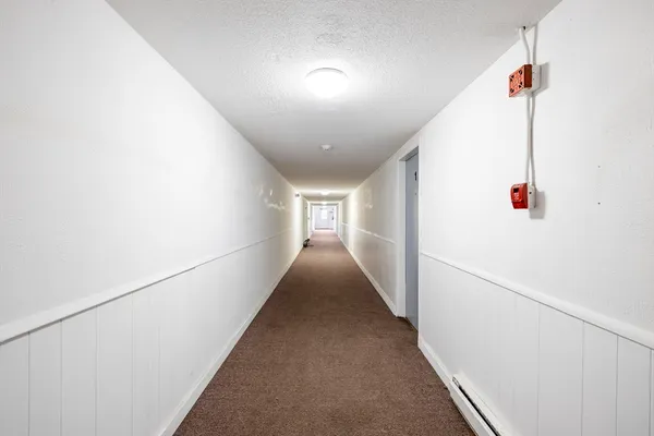 a kitchen with granite countertop cabinets appliances and a sink