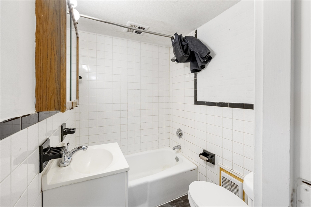 50 East Main Street Orange, MA 01364 - Photo 18 of 23 a bathroom with a sink a toilet and shower