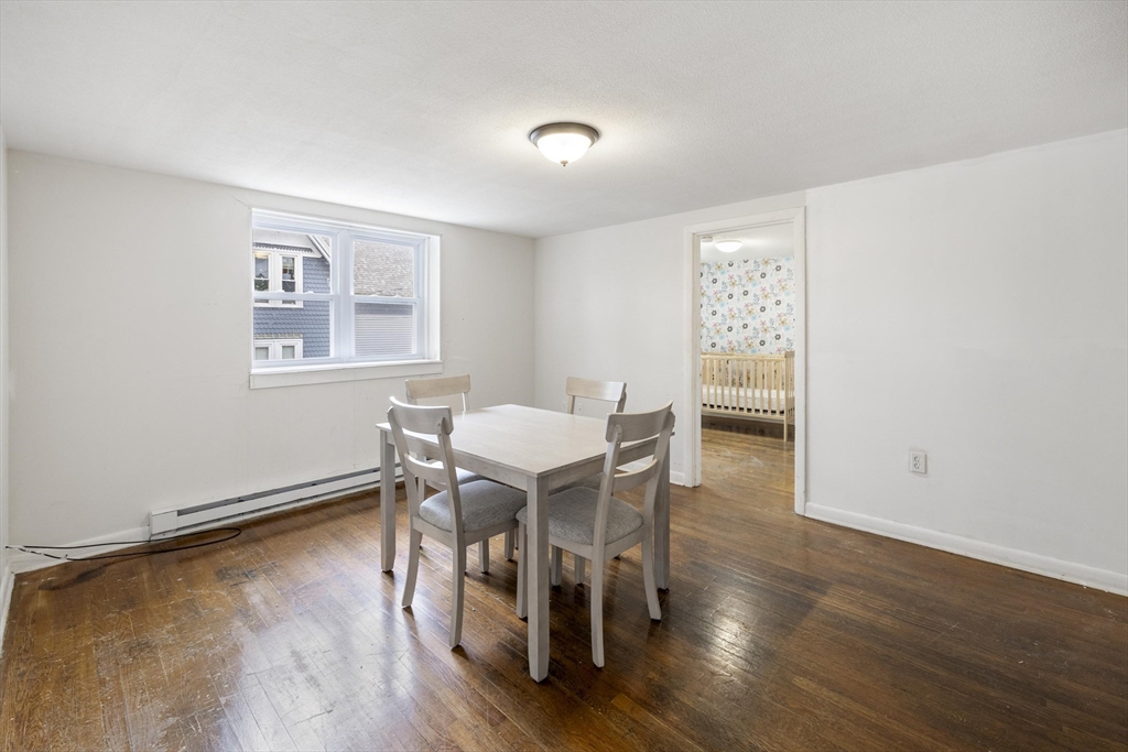 50 East Main Street Orange, MA 01364 - Photo 19 of 23 a view of a dining room with furniture and wooden floor
