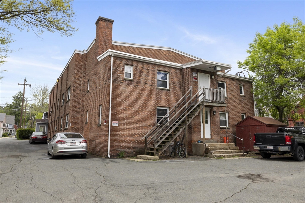 50 East Main Street Orange, MA 01364 - Photo 3 of 23 a car parked in front of a house
