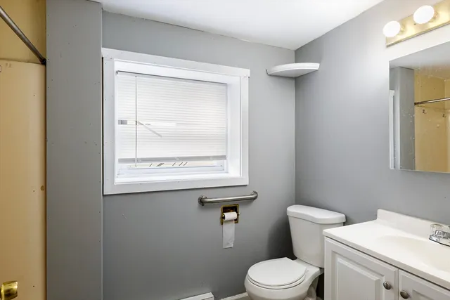 a white toilet sitting next to a bathroom sink