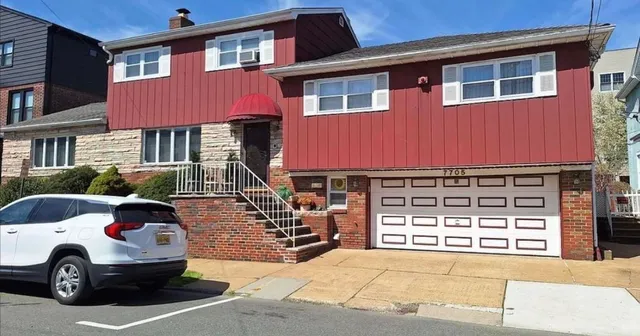 a front view of a house with parking space