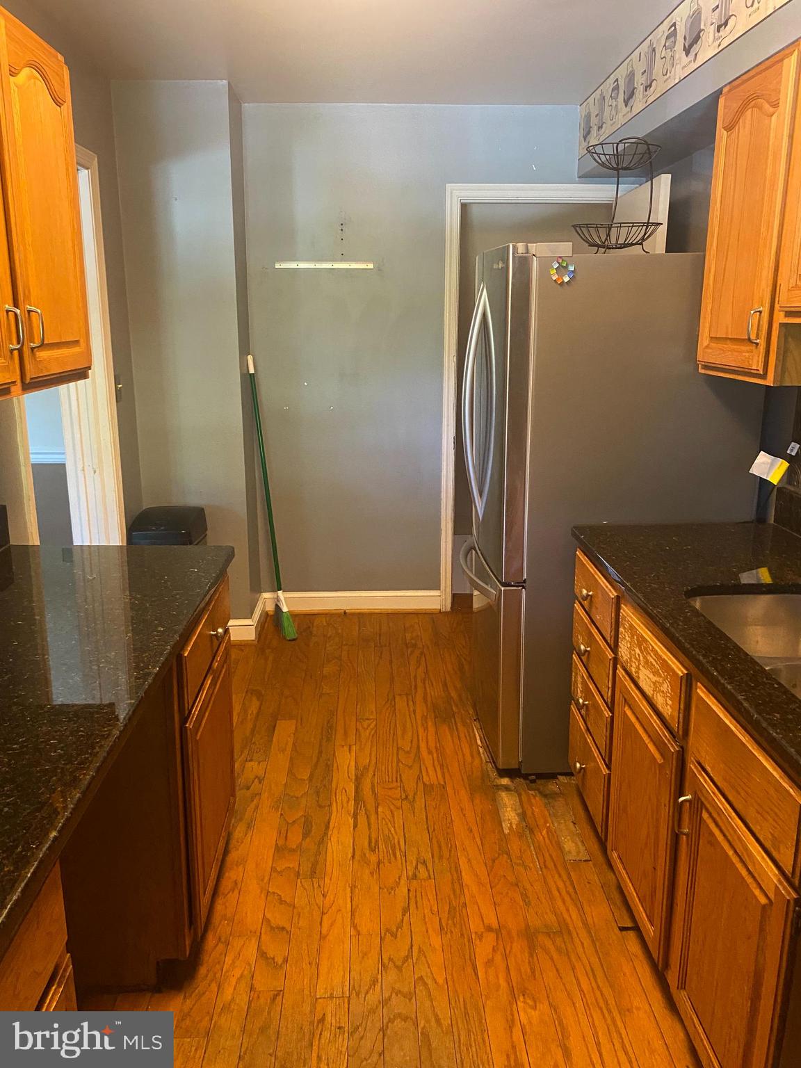 906 Masefield Road Baltimore, MD 21207 - Photo 3 of 22 a bathroom with a sink and a large mirror
