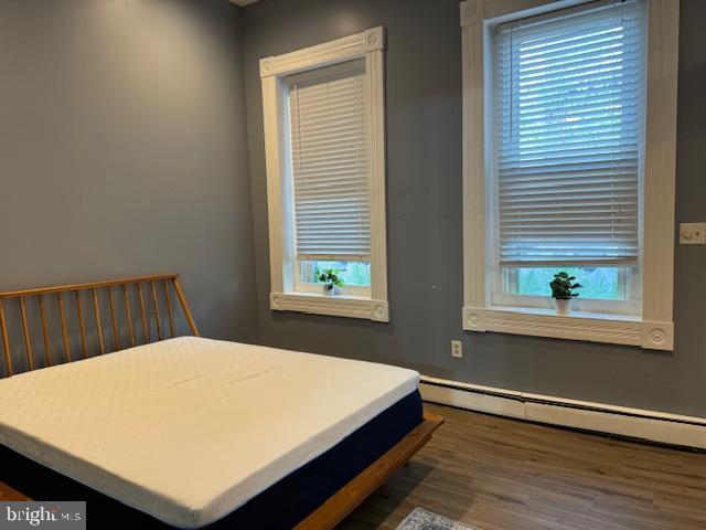 1110 South Potomac Street Baltimore, MD 21224 - Photo 14 of 22 a bed sitting in a bedroom next to a window