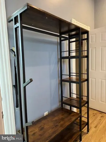 a view of a room with wooden floor and closet