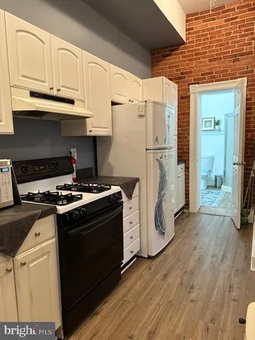 a kitchen with wooden cabinets and a stove top oven