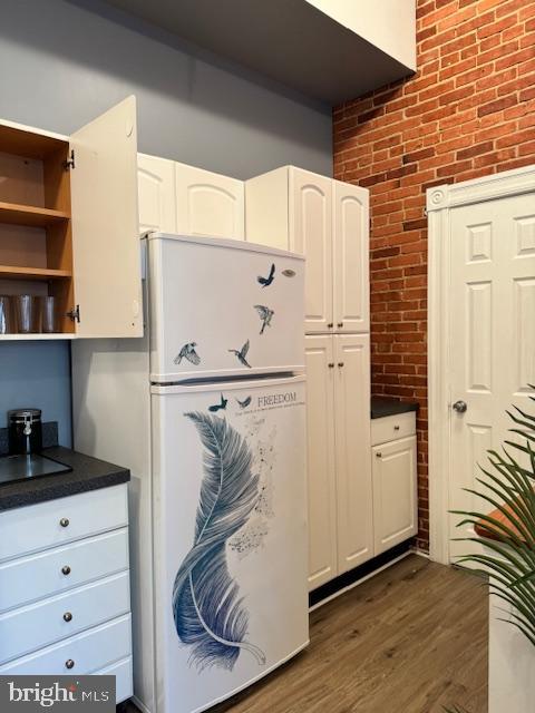 1110 South Potomac Street Baltimore, MD 21224 - Photo 4 of 22 a kitchen with a refrigerator and white cabinets