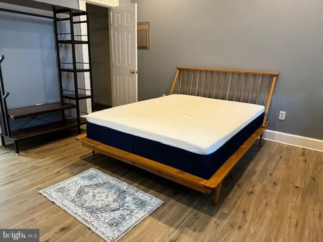 a view of a hallway with wooden floor and stairs