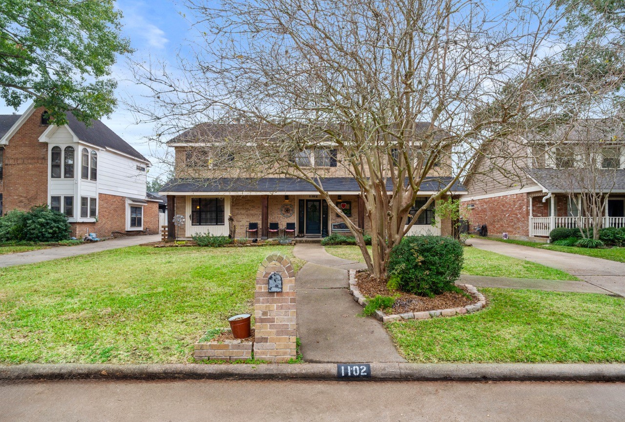 a front view of a house with a yard and porch