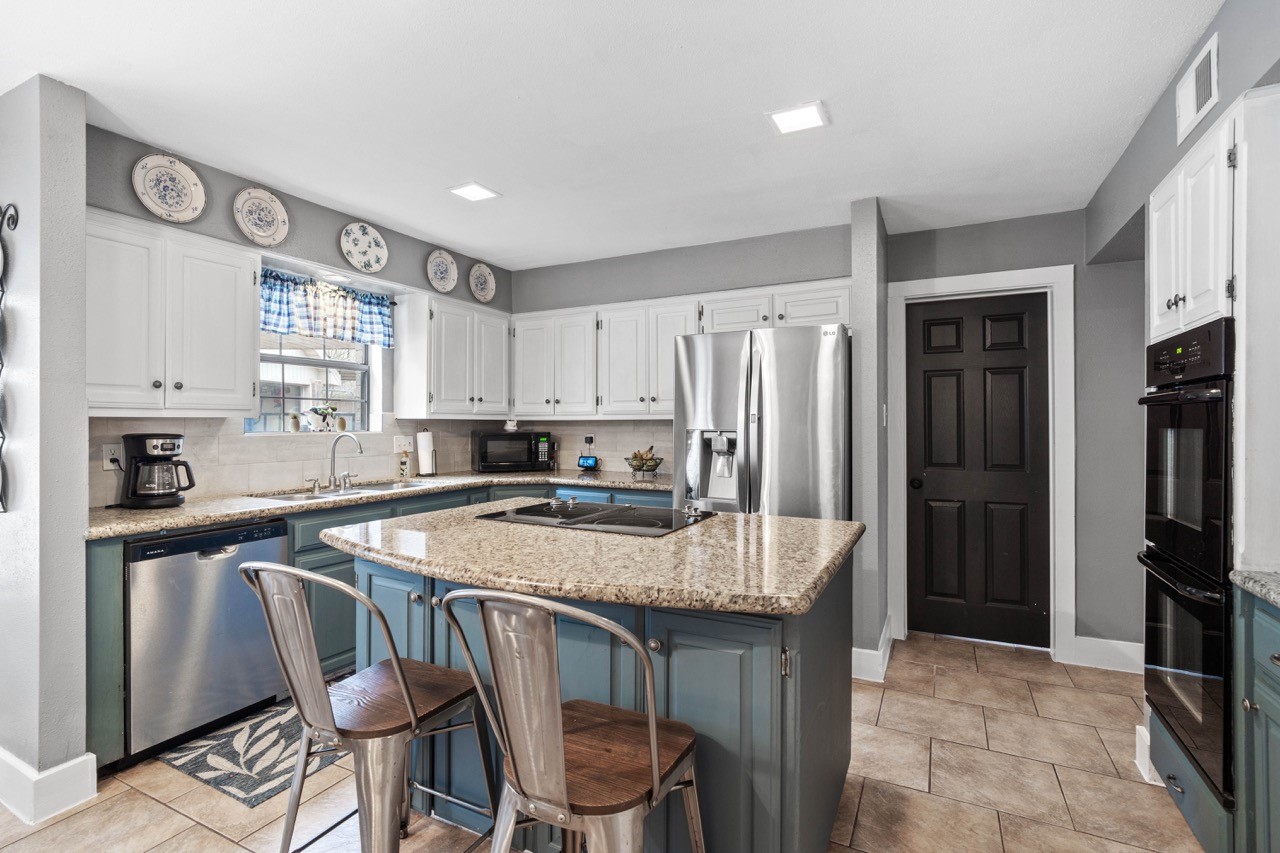 1102 Sherfield Ridge Drive Katy, TX 77450 - Photo 15 of 39 a kitchen with stainless steel appliances granite countertop a stove refrigerator sink and cabinets