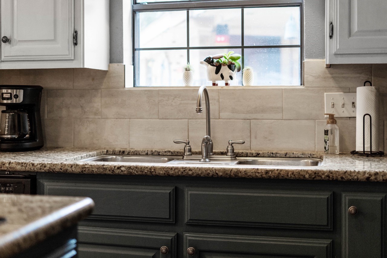 1102 Sherfield Ridge Drive Katy, TX 77450 - Photo 18 of 39 a kitchen with granite countertop a sink and a window