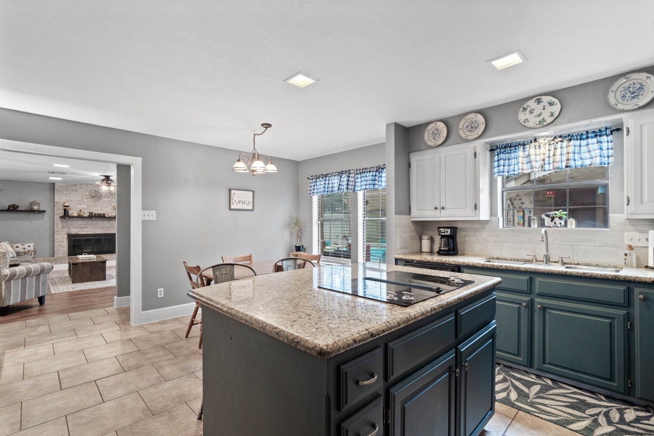 1102 Sherfield Ridge Drive Katy, TX 77450 - Photo 20 of 39 a kitchen with stainless steel appliances granite countertop a sink stove and cabinets