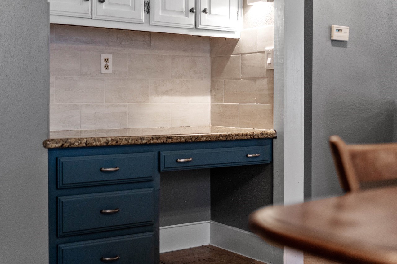 1102 Sherfield Ridge Drive Katy, TX 77450 - Photo 22 of 39 a bathroom with a granite countertop sink and white cabinets