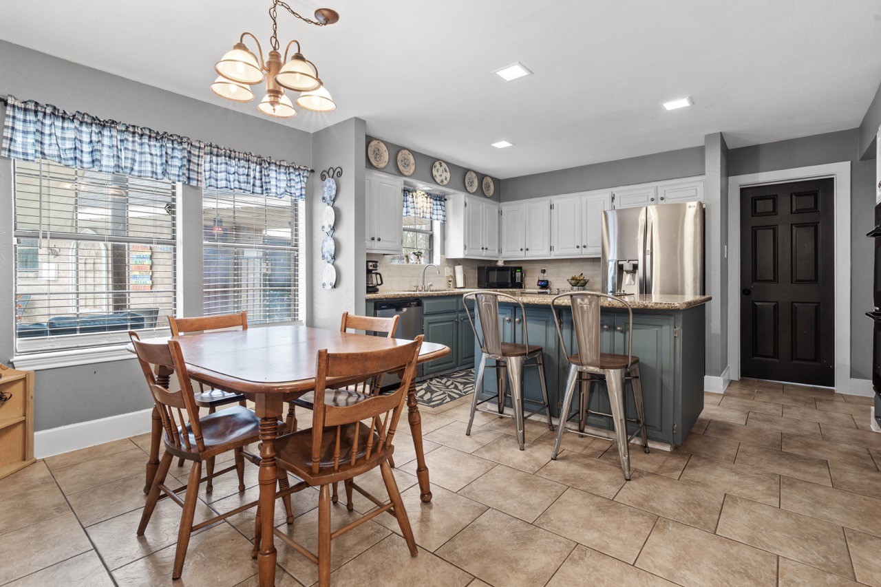 1102 Sherfield Ridge Drive Katy, TX 77450 - Photo 23 of 39 a view of a dining room with furniture and a chandelier