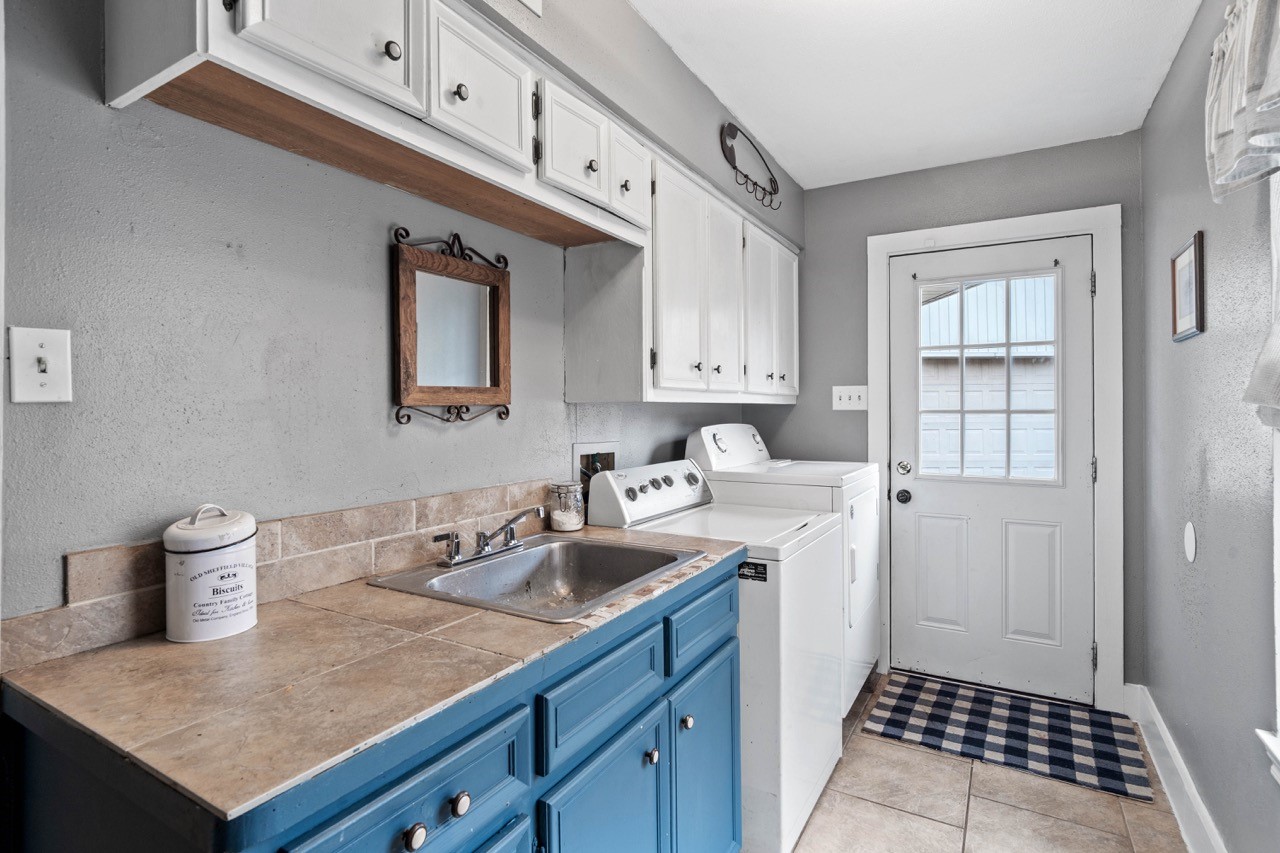 1102 Sherfield Ridge Drive Katy, TX 77450 - Photo 24 of 39 Laundry/utility room just inside the backdoor entrance. Plenty of storage, plus a sink!