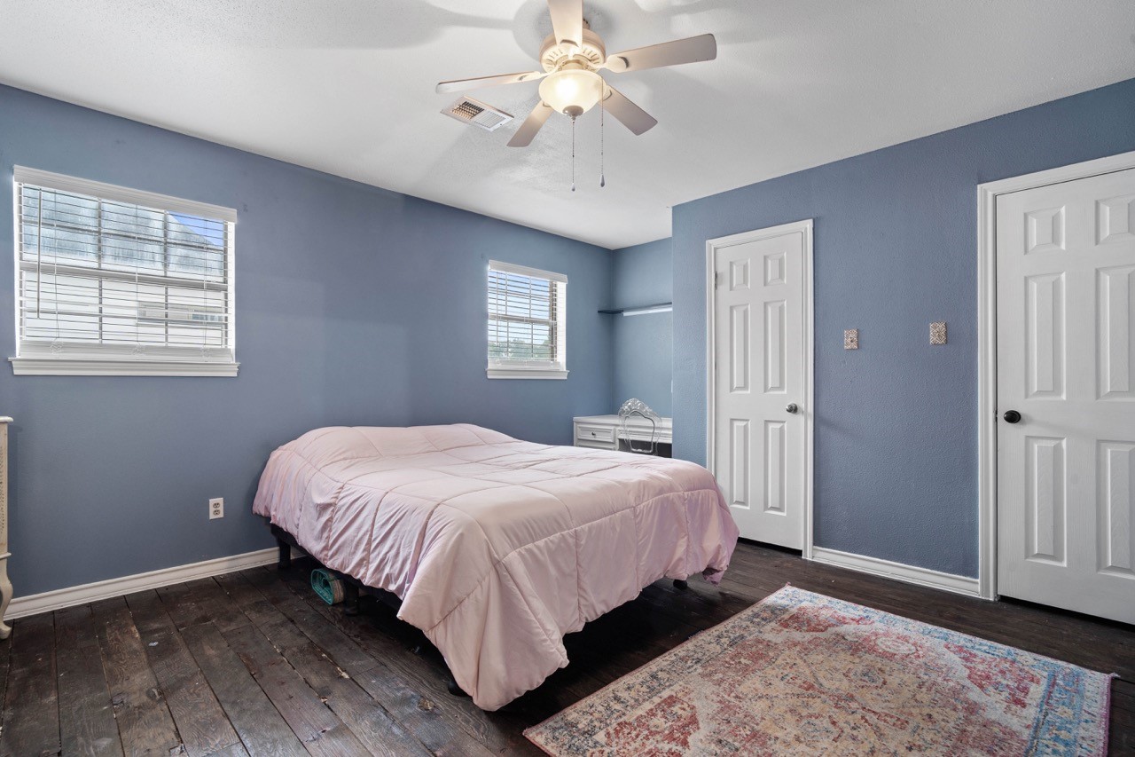 1102 Sherfield Ridge Drive Katy, TX 77450 - Photo 30 of 39 a bedroom with a bed chandelier and a window