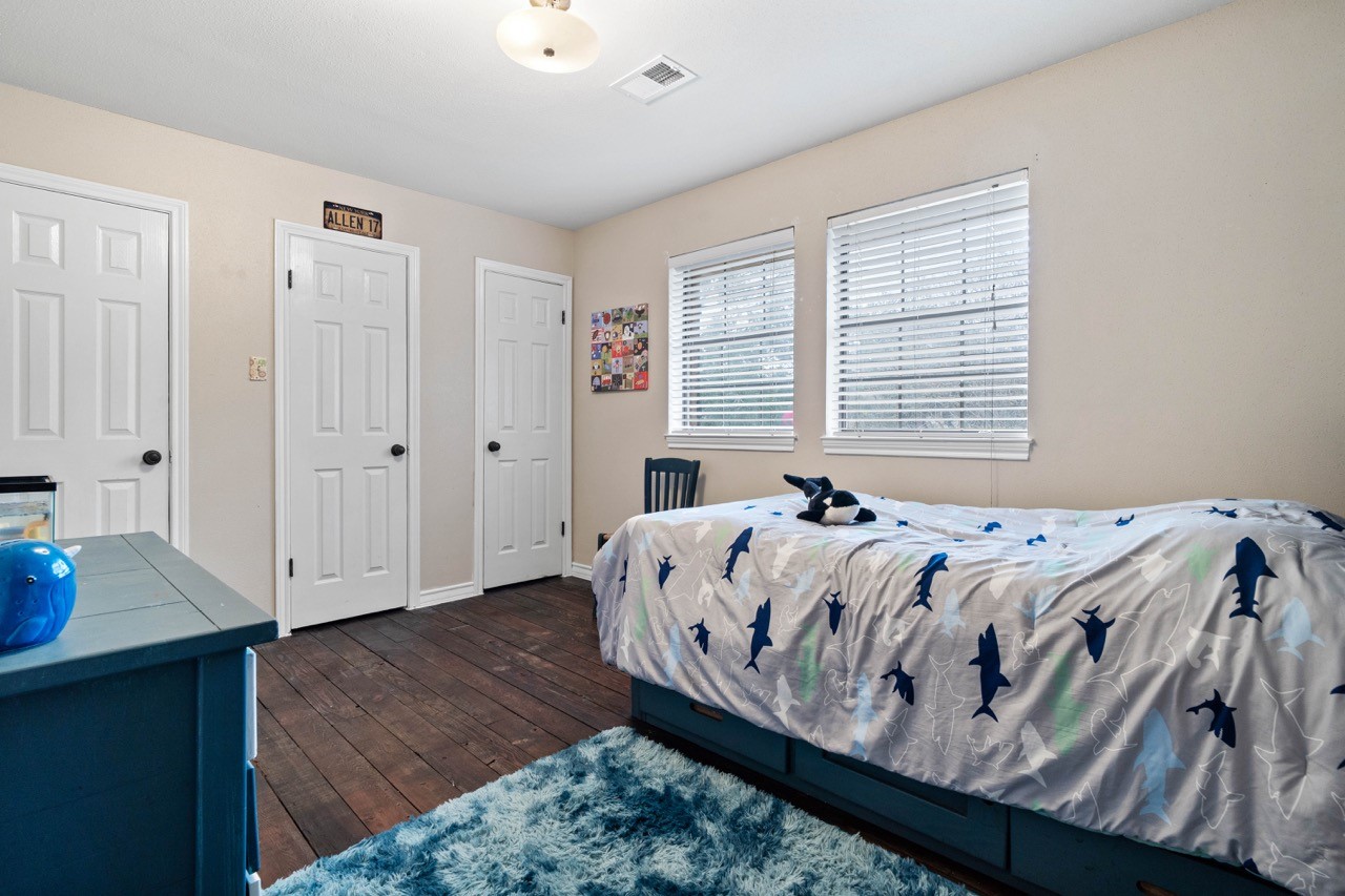 1102 Sherfield Ridge Drive Katy, TX 77450 - Photo 33 of 39 a bed sitting in a bedroom next to a window