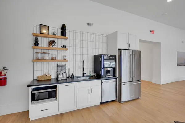 a kitchen with stainless steel appliances a refrigerator and a stove top oven