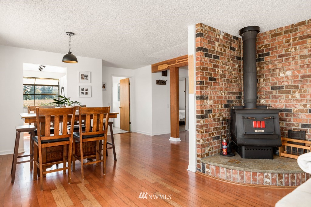6582 Humphrey Road Clinton, WA 98236 - Photo 11 of 39 a view of a a dining room with furniture window and wooden floor