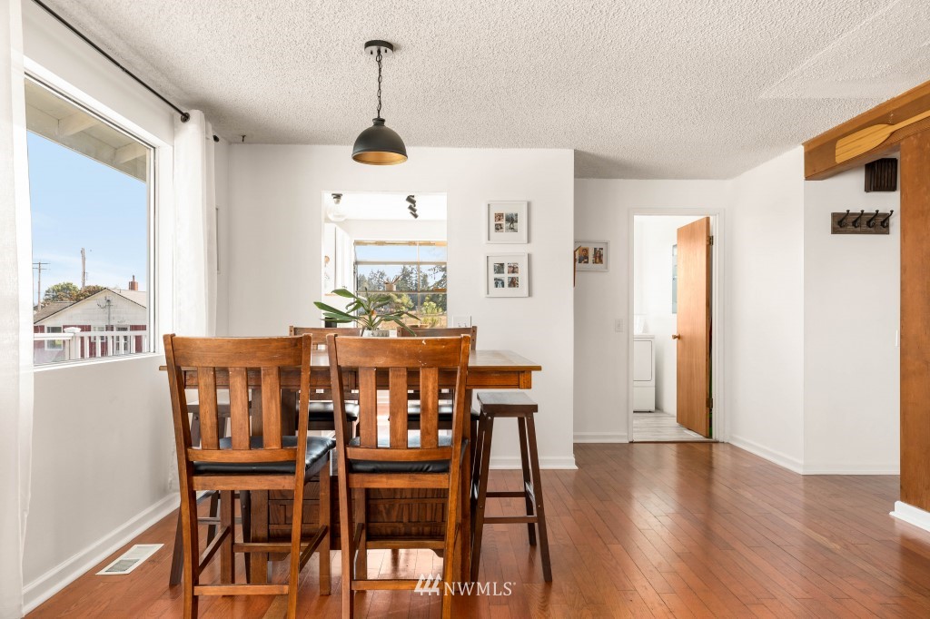 6582 Humphrey Road Clinton, WA 98236 - Photo 12 of 39 a view of a dining room with furniture and wooden floor