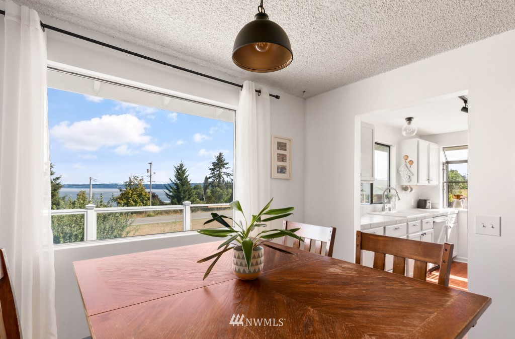 6582 Humphrey Road Clinton, WA 98236 - Photo 14 of 39 a view of a dining room with furniture window and outside view