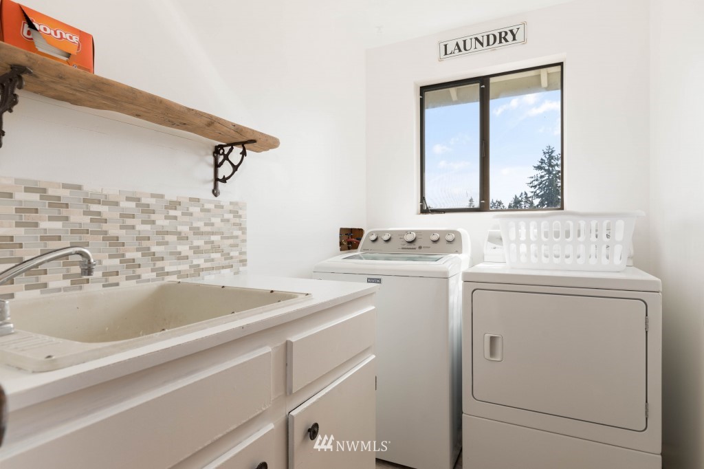 6582 Humphrey Road Clinton, WA 98236 - Photo 20 of 39 a bathroom with a sink and a washing machine