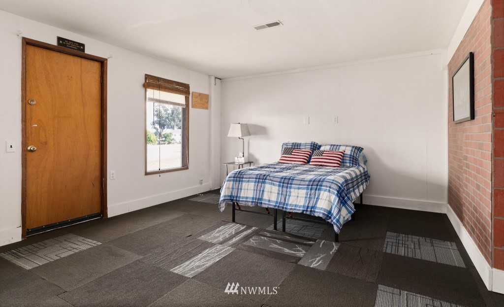 6582 Humphrey Road Clinton, WA 98236 - Photo 29 of 39 a bedroom with a bed and wooden floor