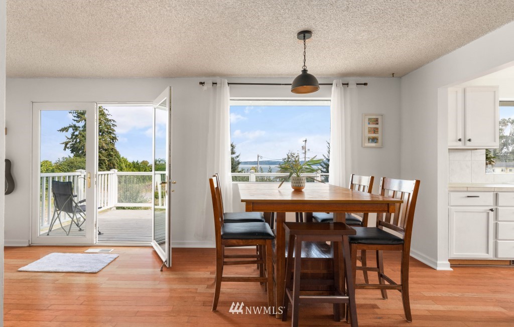 6582 Humphrey Road Clinton, WA 98236 - Photo 4 of 39 a view of a dining room with furniture window and wooden floor