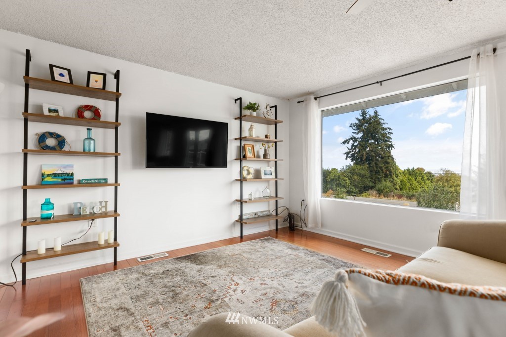6582 Humphrey Road Clinton, WA 98236 - Photo 8 of 39 a living room with furniture and a flat screen tv