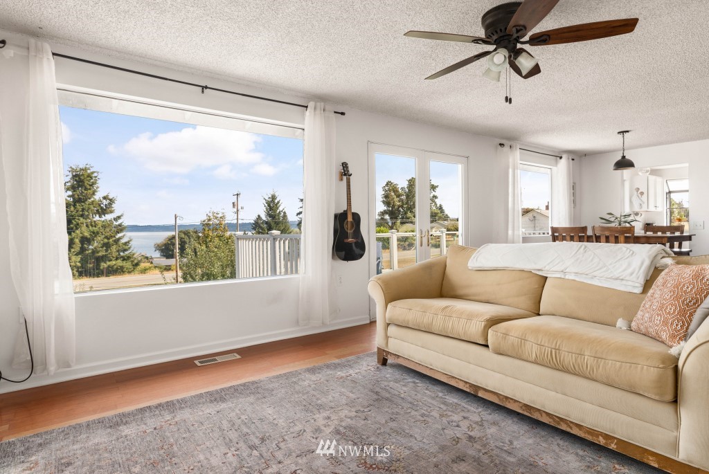6582 Humphrey Road Clinton, WA 98236 - Photo 9 of 39 a living room with furniture and a large window