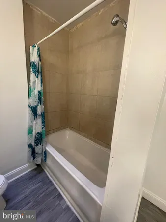 a bathroom with a tub and shower