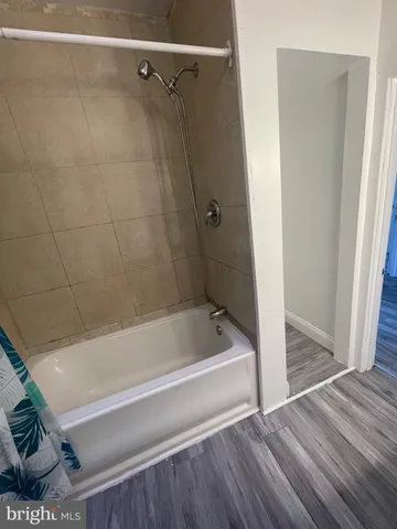 a bathroom with a bathtub and a shower
