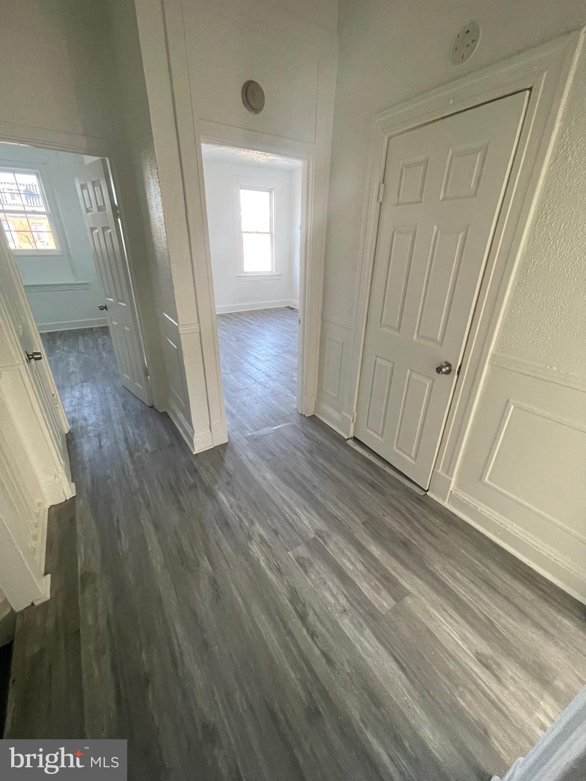 2905 Norfolk Avenue Baltimore, MD 21215 - Photo 19 of 28 a view of a hallway with wooden floor and stairs