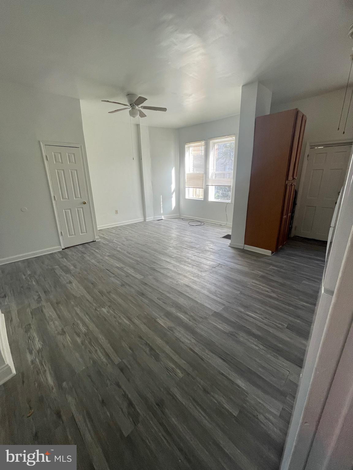 2905 Norfolk Avenue Baltimore, MD 21215 - Photo 6 of 28 an empty room with wooden floor and windows