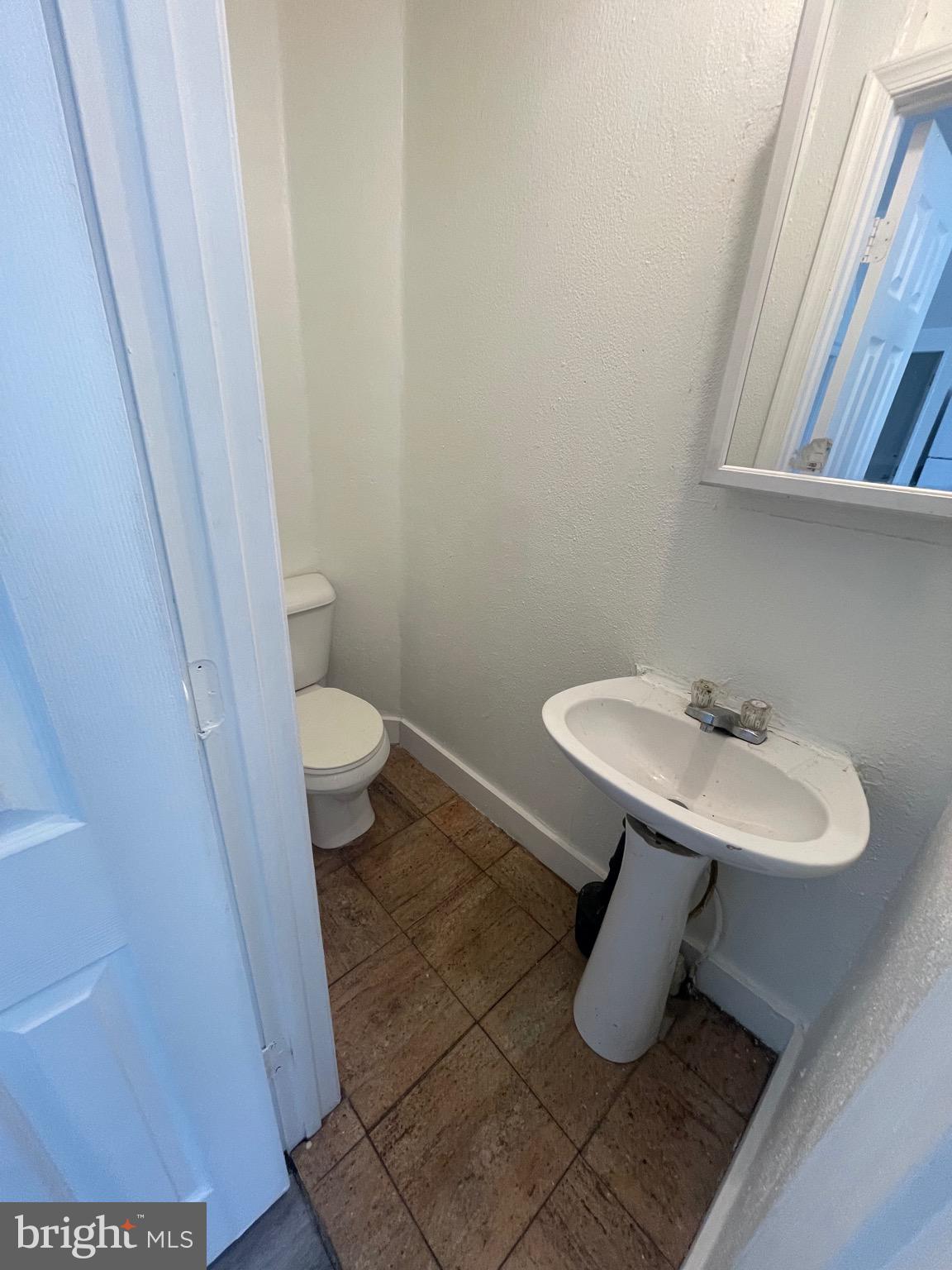 2905 Norfolk Avenue Baltimore, MD 21215 - Photo 7 of 28 a bathroom with a sink and a toilet