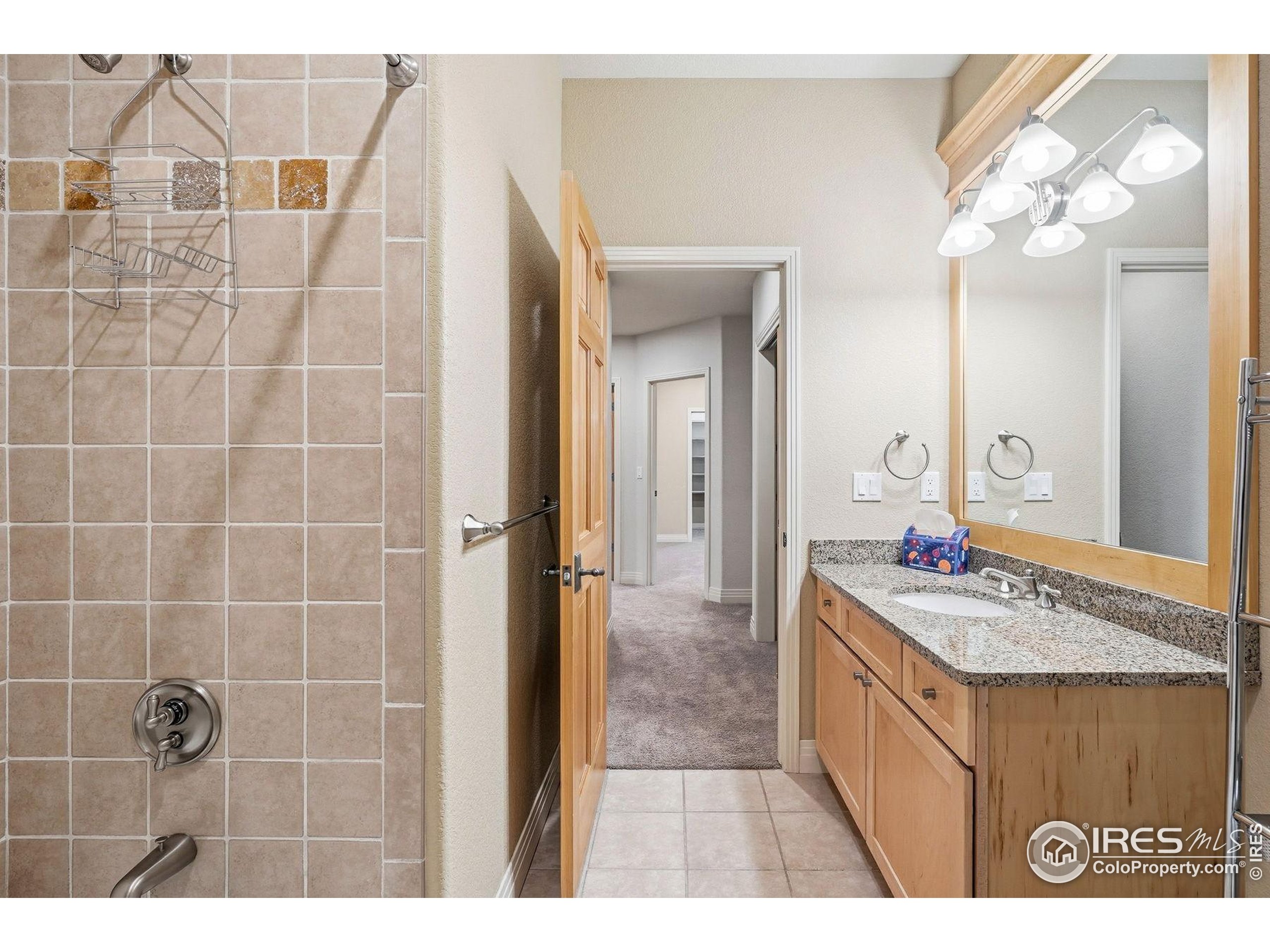 4840 6th Street Boulder, CO 80304 - Photo 37 of 48 a bathroom with a sink a mirror and a shower