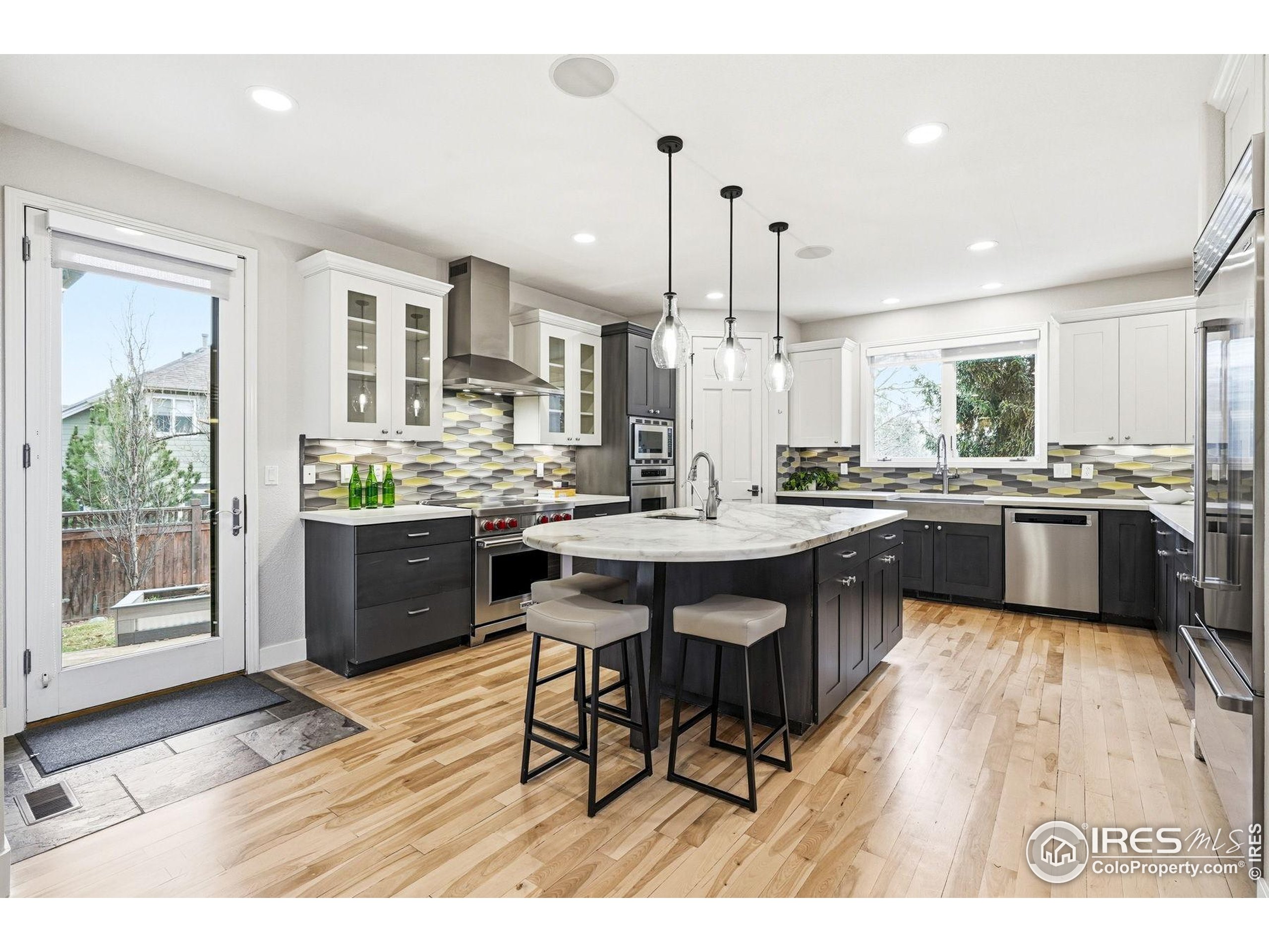 4840 6th Street Boulder, CO 80304 - Photo 9 of 48 a open kitchen with stainless steel appliances kitchen island granite countertop a sink table and chairs