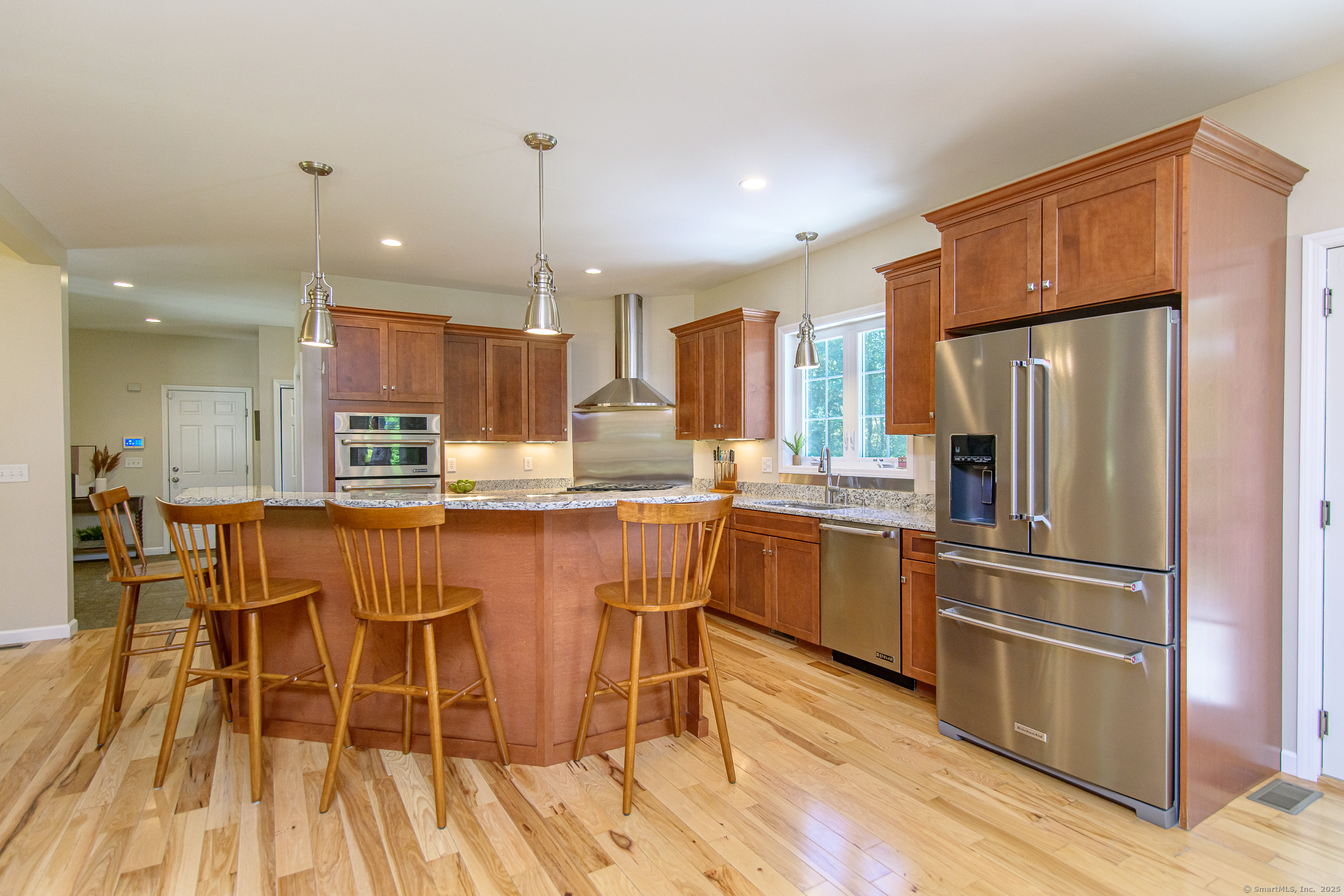 189 Center Road Woodstock, CT 06281 - Photo 15 of 40 a kitchen with stainless steel appliances a refrigerator a stove top oven and a center island