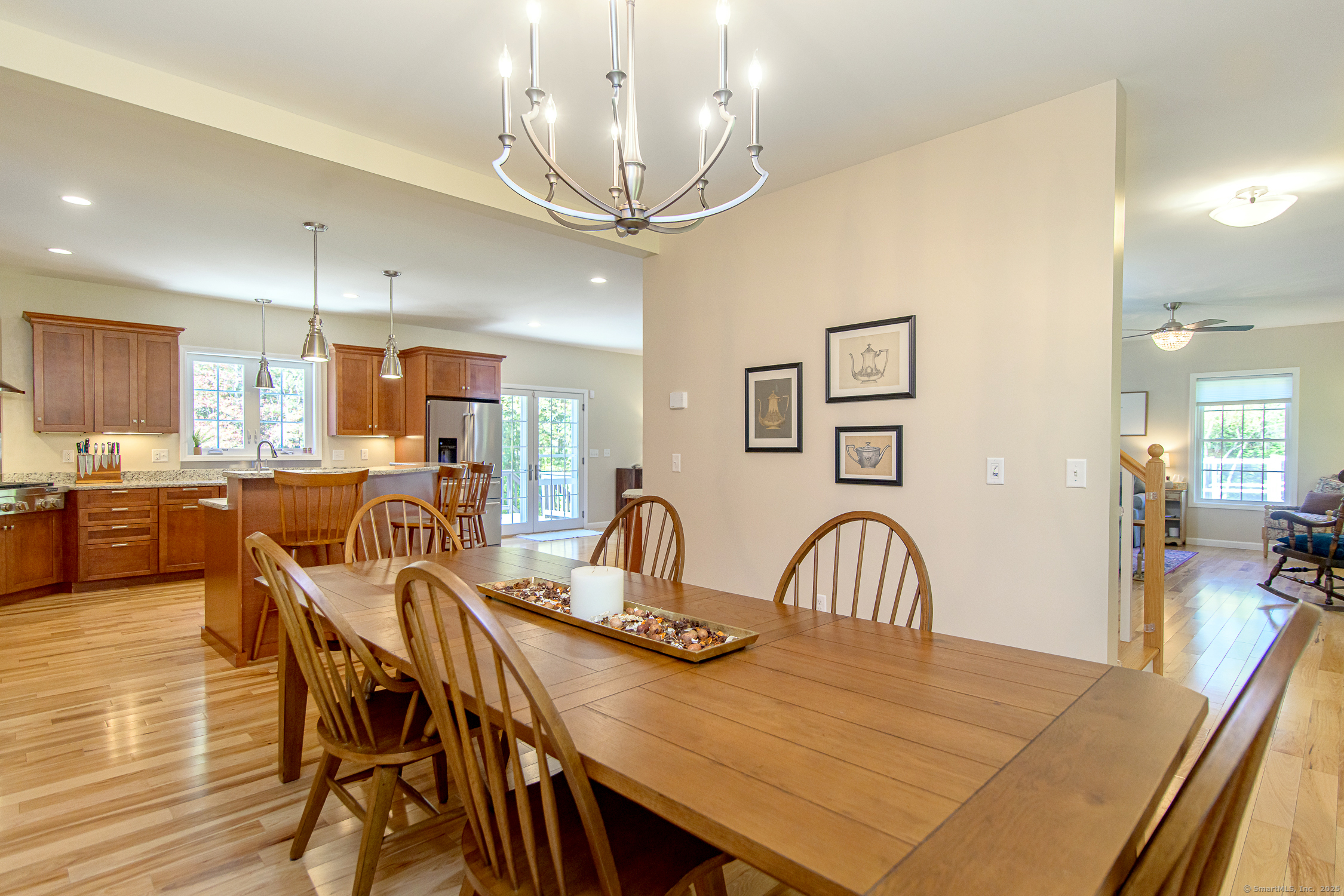 189 Center Road Woodstock, CT 06281 - Photo 22 of 40 a view of a dining room and livingroom with furniture wooden floor a chandelier