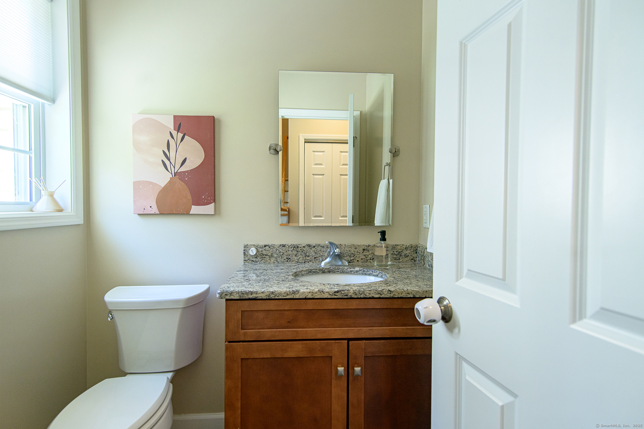 189 Center Road Woodstock, CT 06281 - Photo 25 of 40 a bathroom with a granite countertop toilet sink and mirror