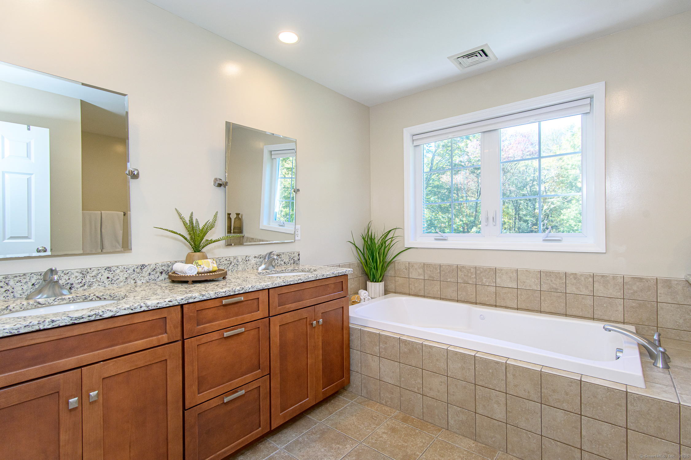 189 Center Road Woodstock, CT 06281 - Photo 32 of 40 a bathroom with a granite countertop tub a sink and a large window