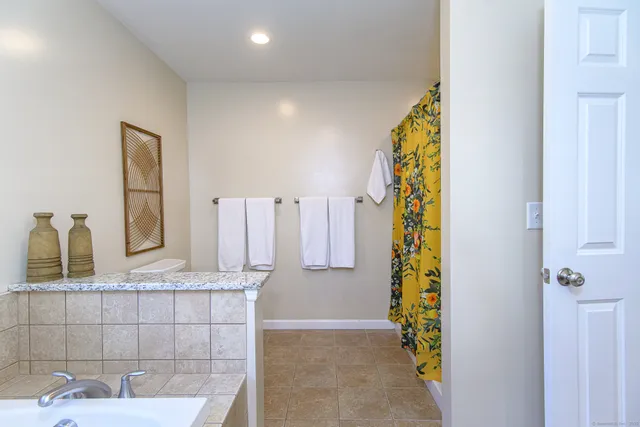 a view of a livingroom with furniture and a flat screen tv