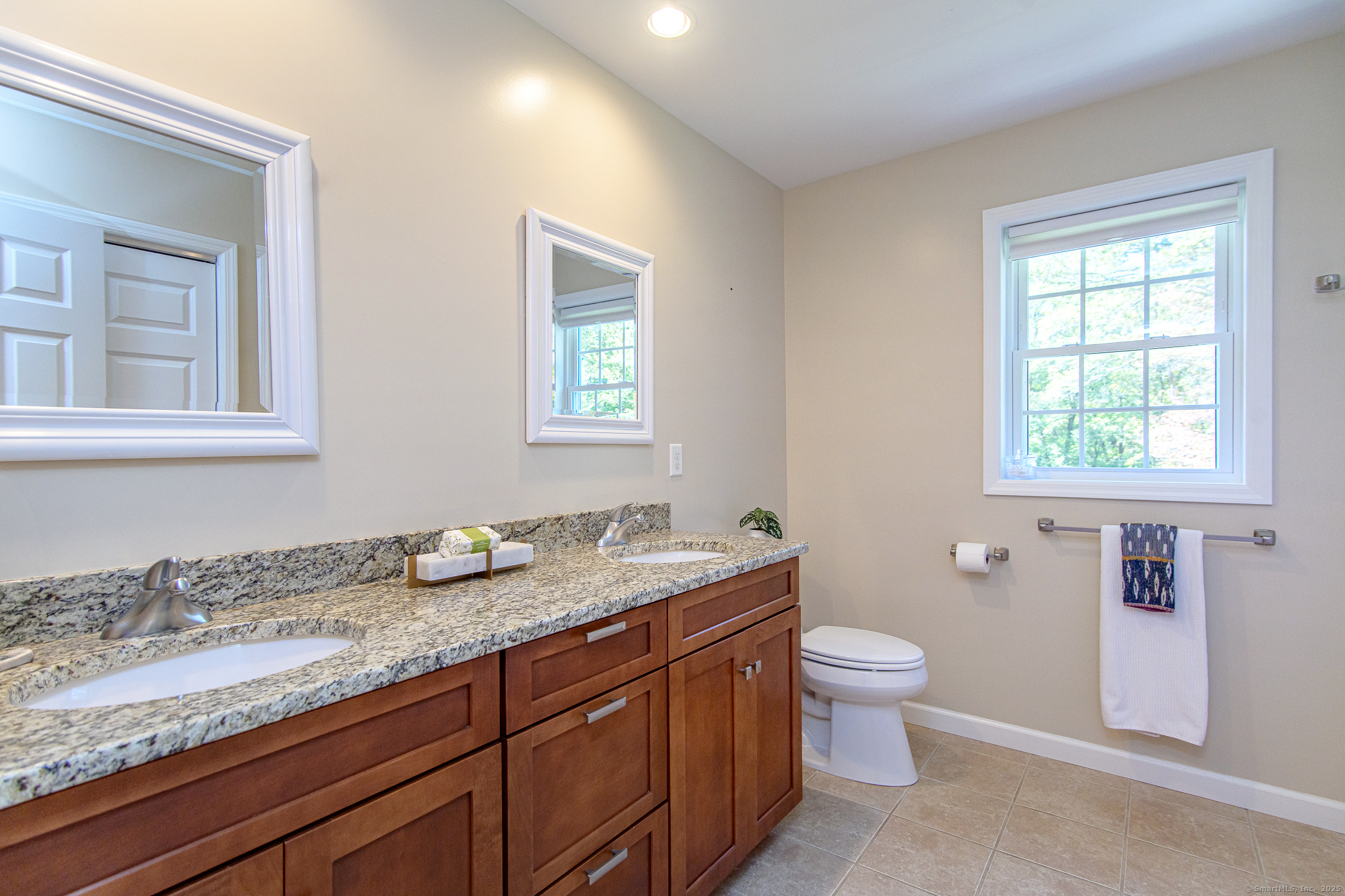 189 Center Road Woodstock, CT 06281 - Photo 36 of 40 a bathroom with a granite countertop sink a toilet and a window