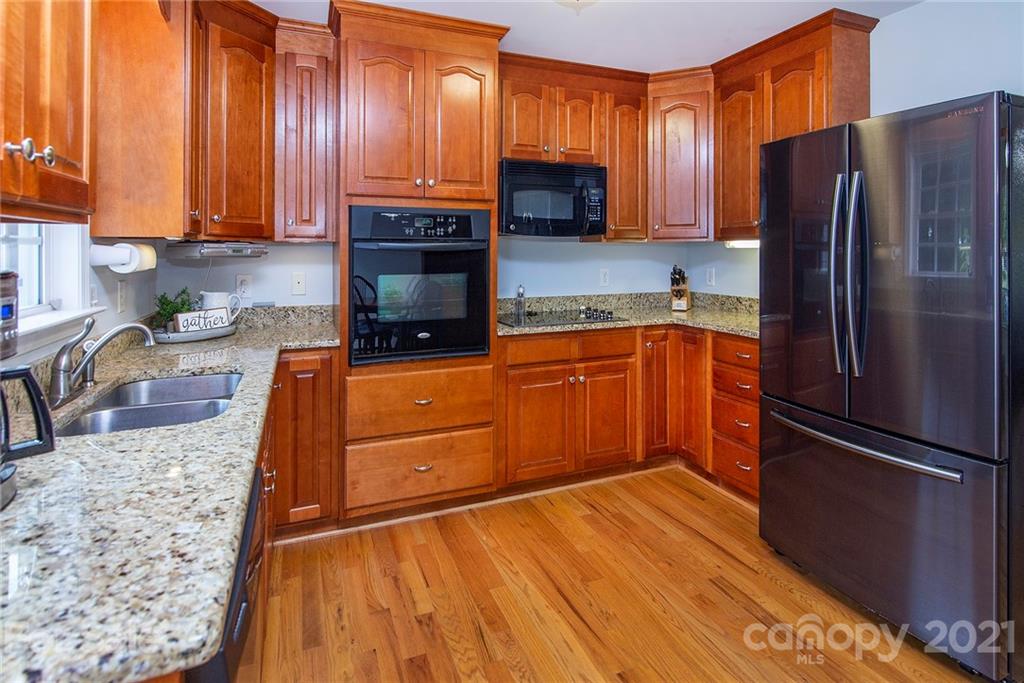 5019 King Wilkinson Road Denver, NC 28037 - Photo 8 of 27 a kitchen with stainless steel appliances granite countertop a refrigerator sink and cabinets