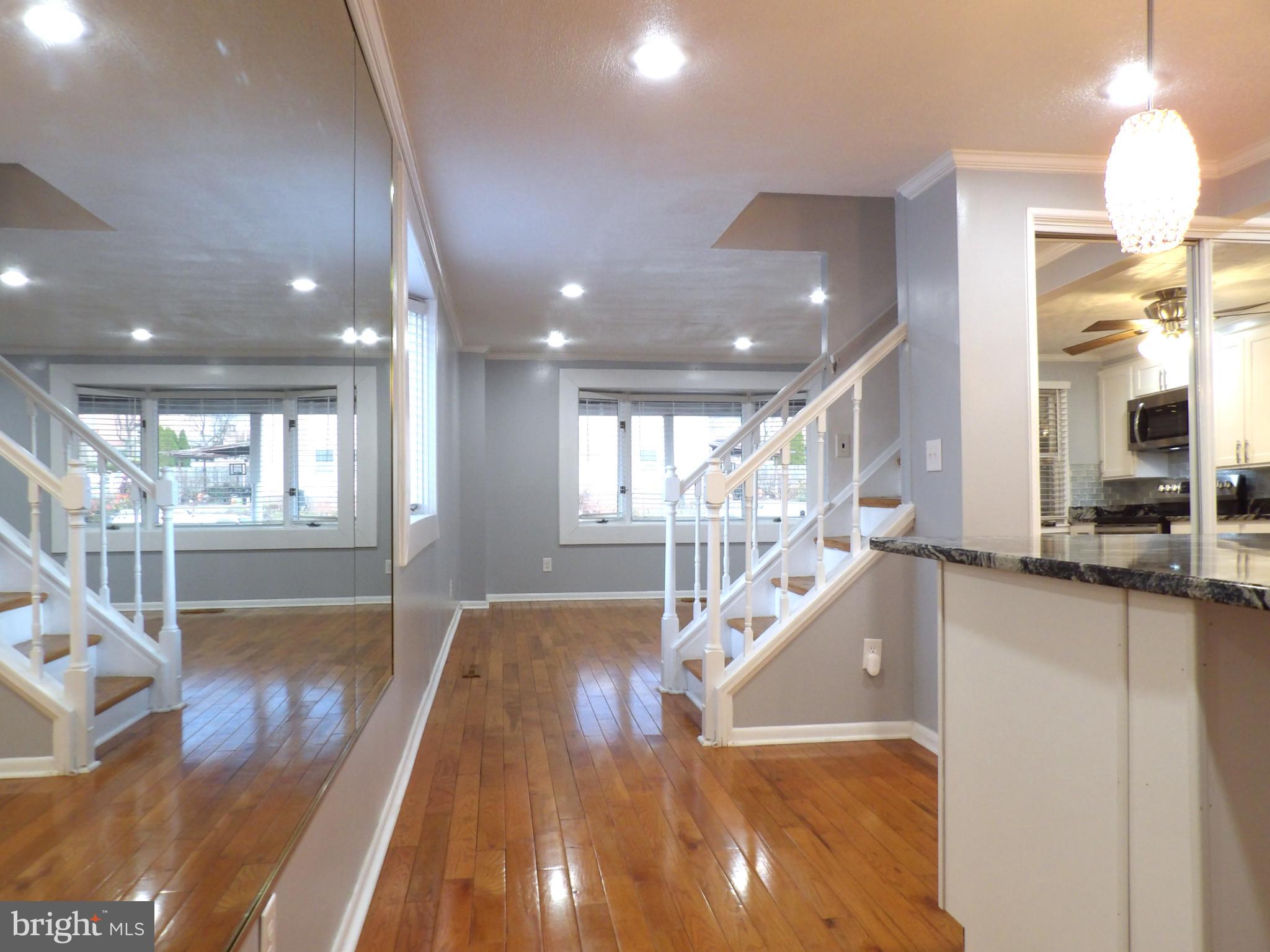 901 Grovehill Road Baltimore, MD 21227 - Photo 13 of 49 a view of a living room and kitchen with a large window