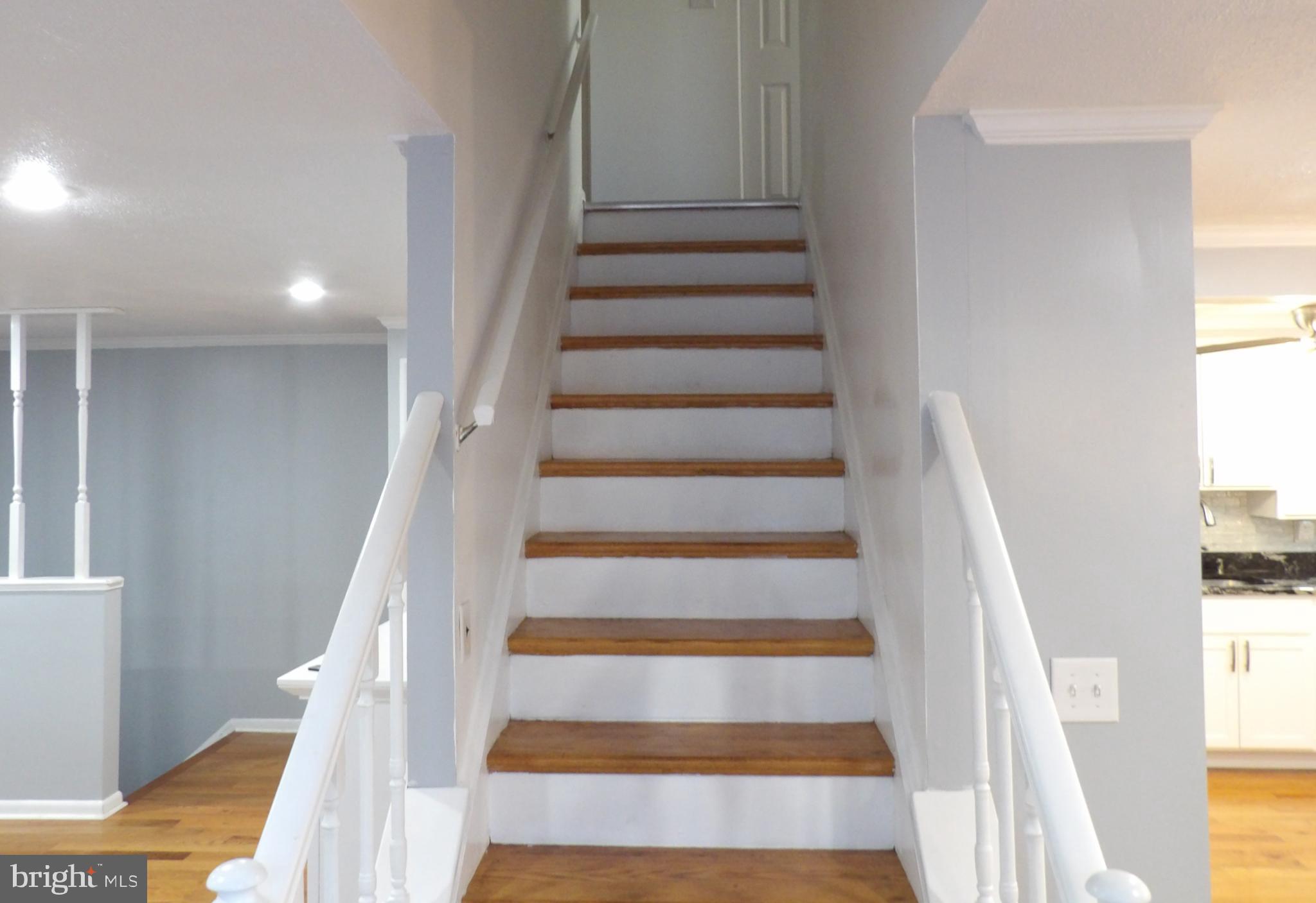 901 Grovehill Road Baltimore, MD 21227 - Photo 15 of 49 a view of staircase with white walls and windows