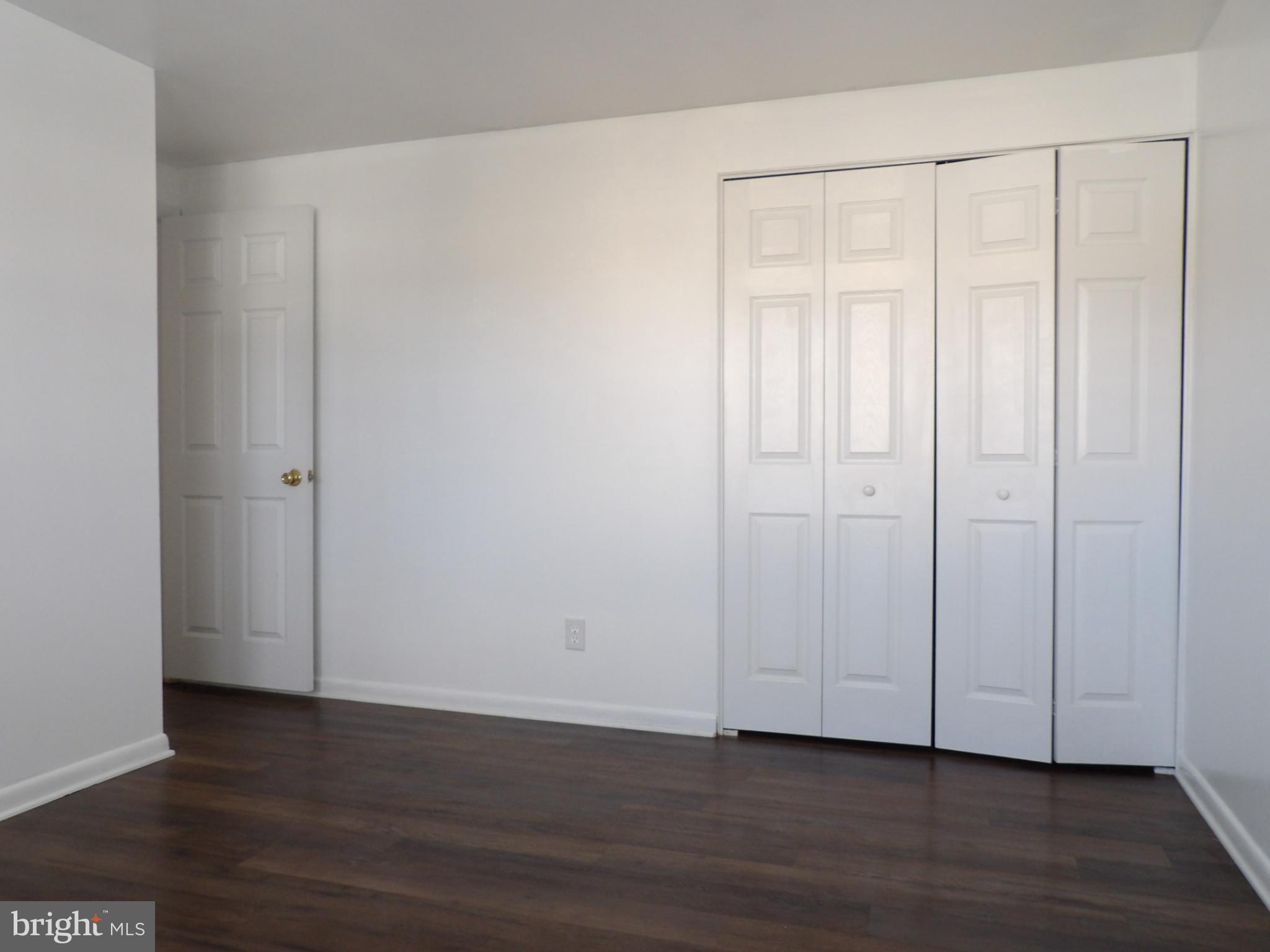 901 Grovehill Road Baltimore, MD 21227 - Photo 19 of 49 a view of an empty room with wooden floor